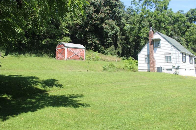 67 McMichael Road Carnegie, PA 15106 - Photo 14 of 17 Left side of the house. Property goes into the wooded area.