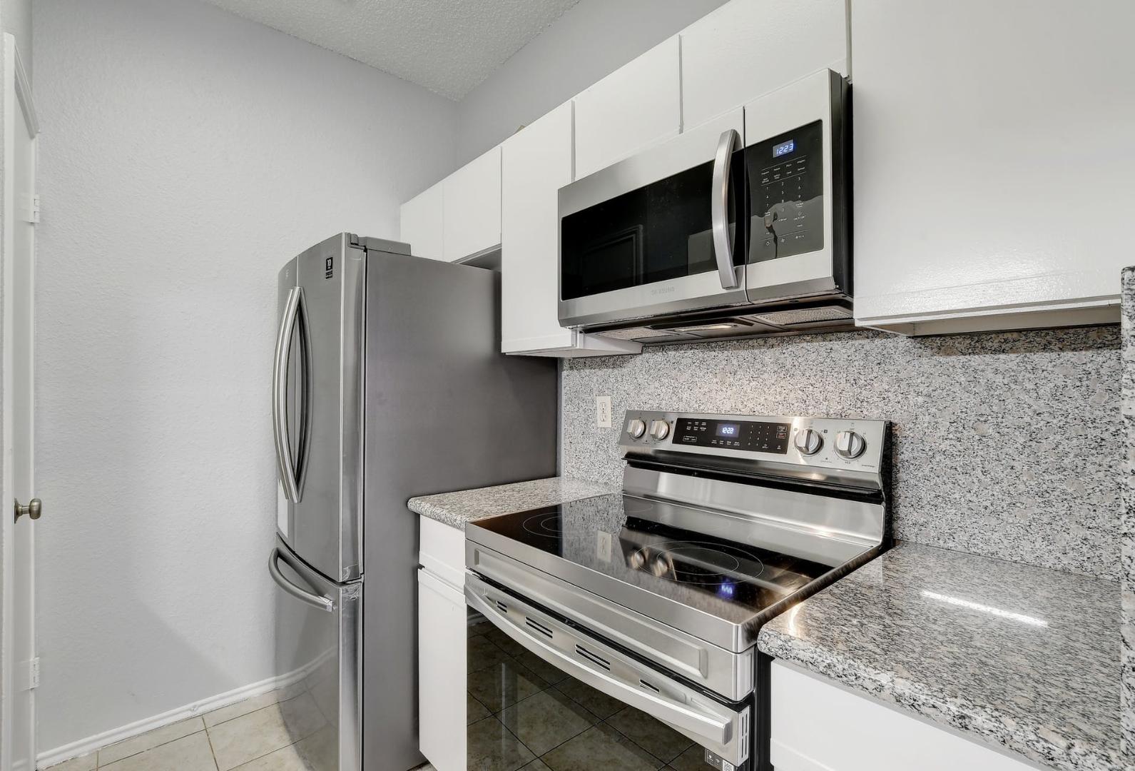 2804 Rio Grande Street, Unit 310 Austin, TX 78705 - Photo 8 of 22 Culinary delights await in this modern kitchen featuring gleaming stainless steel appliances.