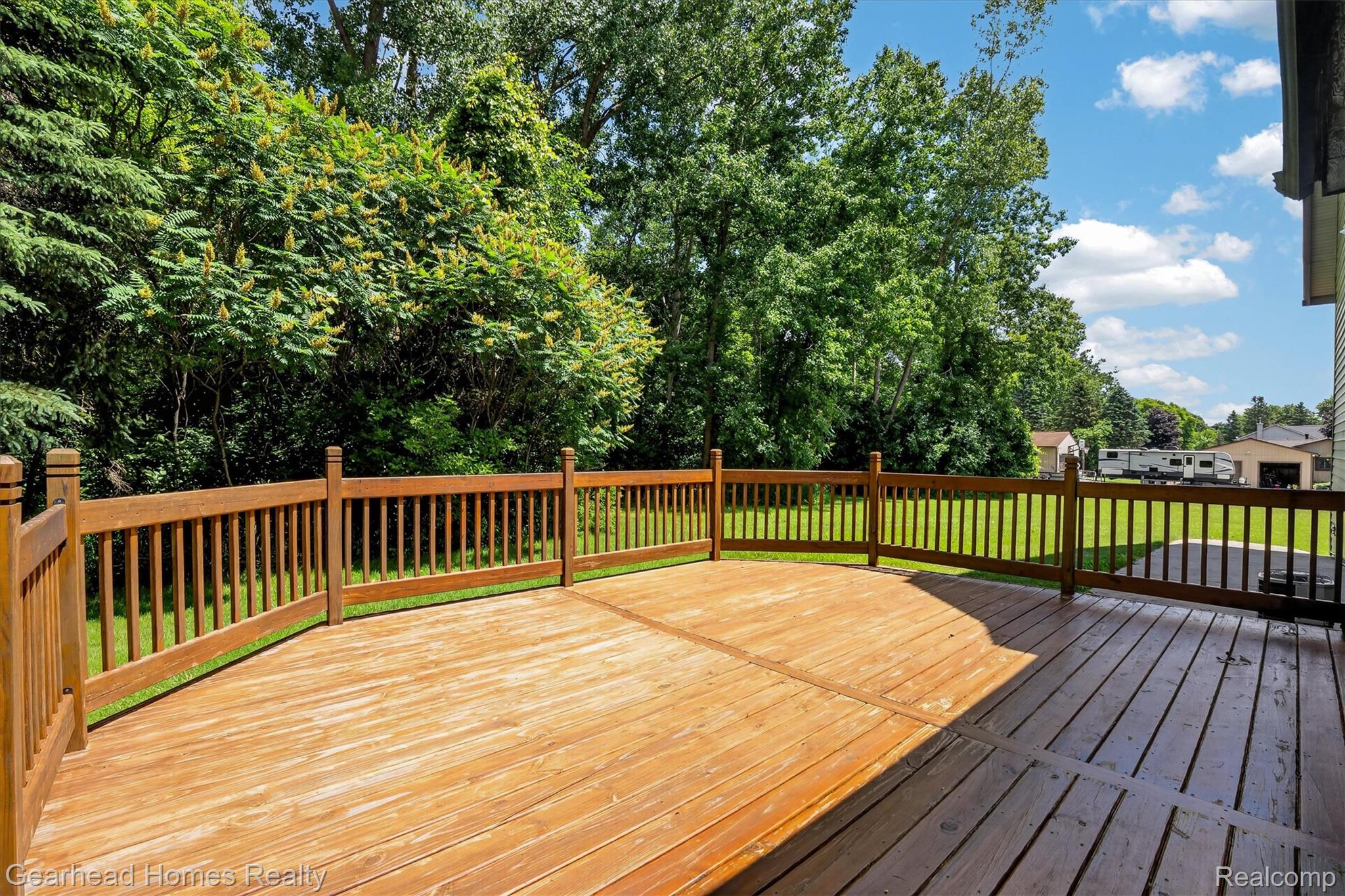 3486 West Drahner Road Oxford, MI 48371 - Photo 19 of 51 Spacious wooden deck with a curved railing