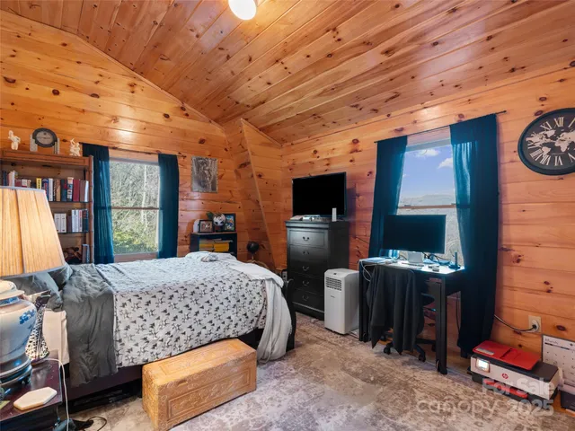 a bedroom with furniture and a window