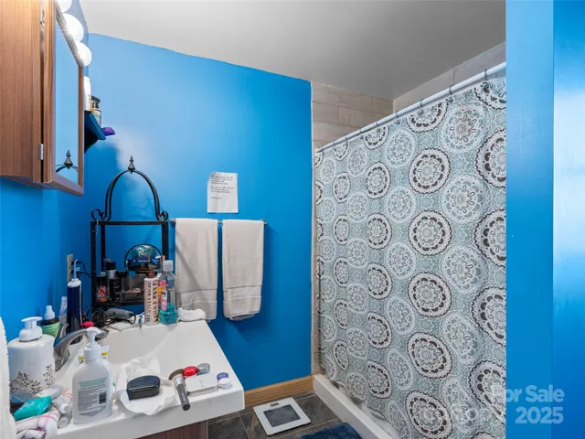 a bathroom with a sink toilet and mirror