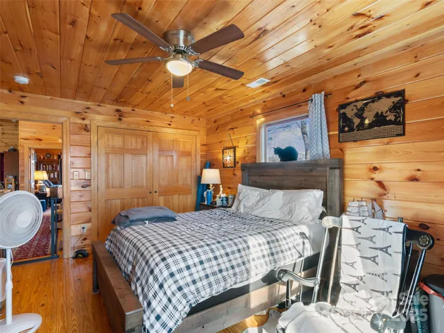 a bedroom with a bed a mirror and desk