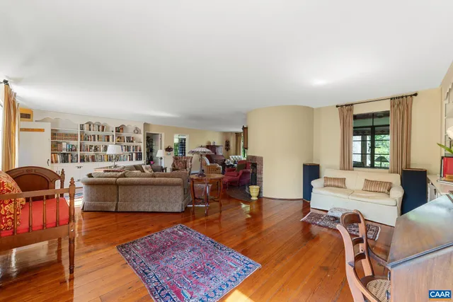 a living room with furniture rug and wooden floor