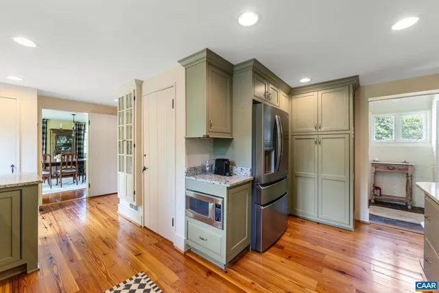 a kitchen with stainless steel appliances granite countertop a refrigerator a sink and a stove