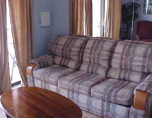 a large bed sitting in a bedroom next to a window