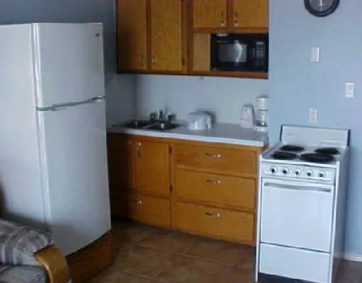 a kitchen with a refrigerator and a stove