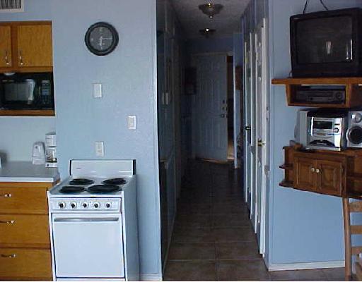3938 Surfside, Unit 1316 1316 Corpus Christi, TX 78402 - Photo 5 of 7 a kitchen with a stove and a refrigerator