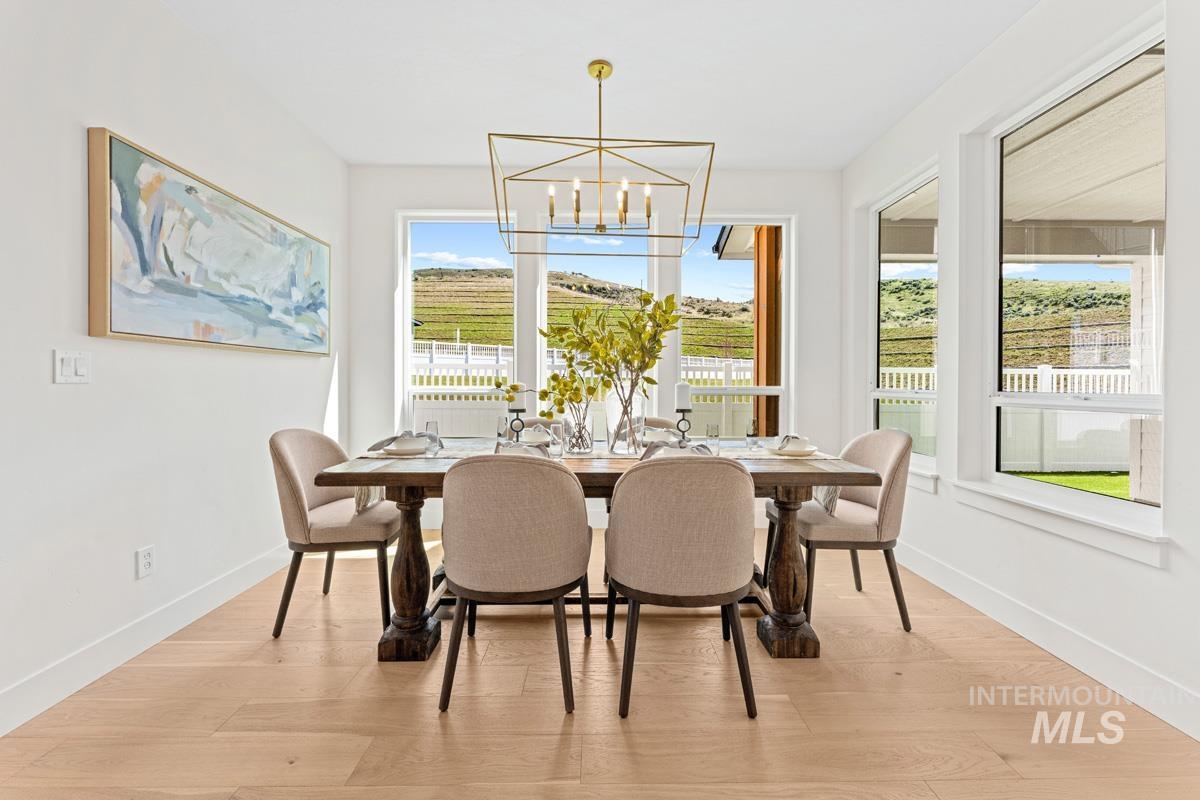 13374 North Spring Creek Way Boise, ID 83714 - Photo 11 of 49 Dining space featuring light wood-style flooring and suspended lighting