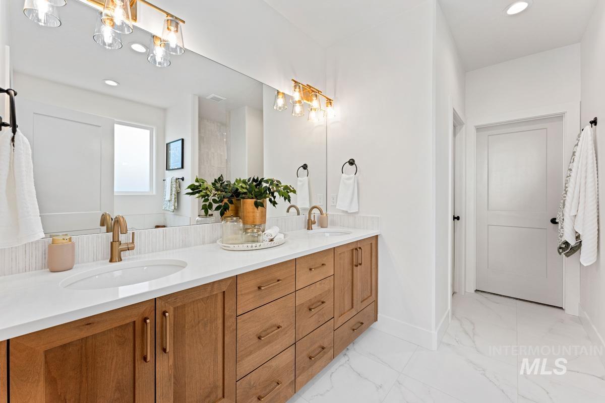 13374 North Spring Creek Way Boise, ID 83714 - Photo 17 of 49 Bathroom featuring double vanity, recessed lighting, and light marble finish floors