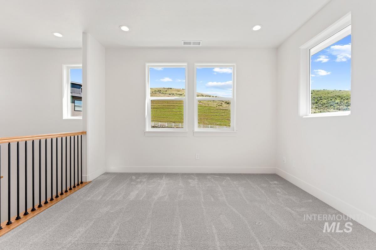 13374 North Spring Creek Way Boise, ID 83714 - Photo 20 of 49 Spare room with light carpet, healthy amount of natural light, and recessed lighting