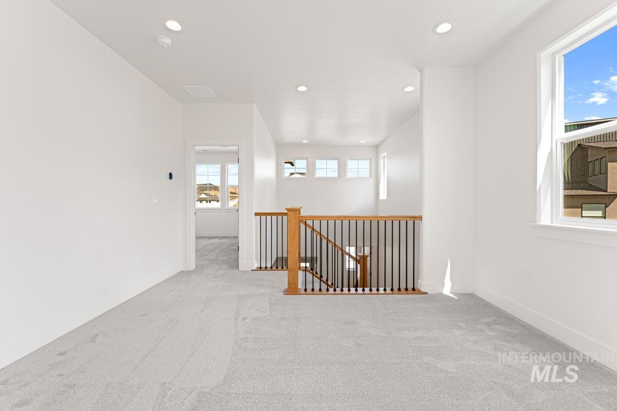 13374 North Spring Creek Way Boise, ID 83714 - Photo 21 of 49 Unfurnished room with light colored carpet and recessed lighting