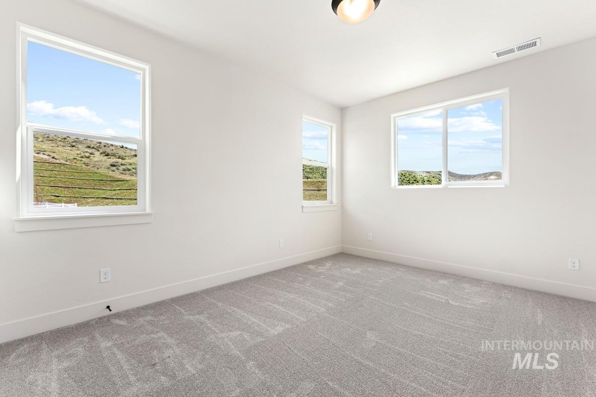 13374 North Spring Creek Way Boise, ID 83714 - Photo 22 of 49 Spare room featuring light colored carpet and baseboards