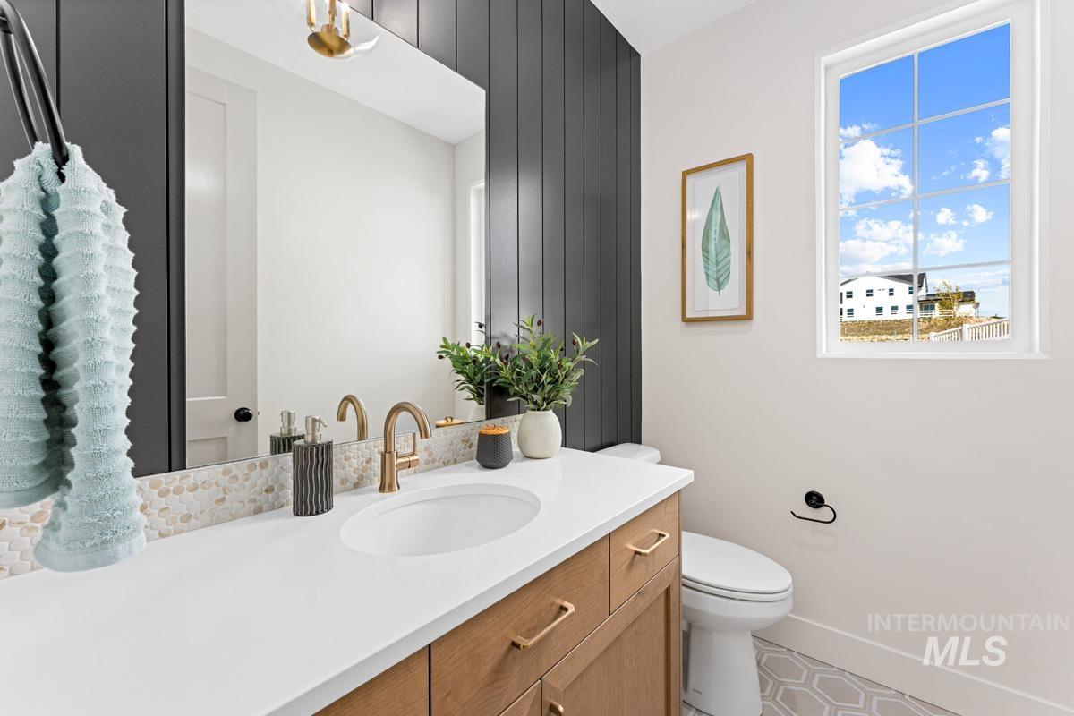 13374 North Spring Creek Way Boise, ID 83714 - Photo 23 of 49 Bathroom featuring vanity and wooden walls