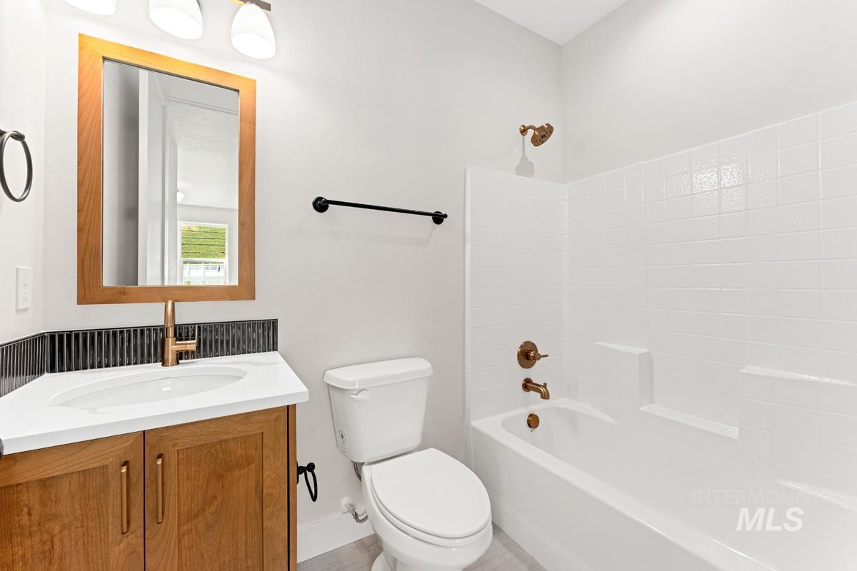13374 North Spring Creek Way Boise, ID 83714 - Photo 29 of 49 Bathroom featuring vanity and washtub / shower combination