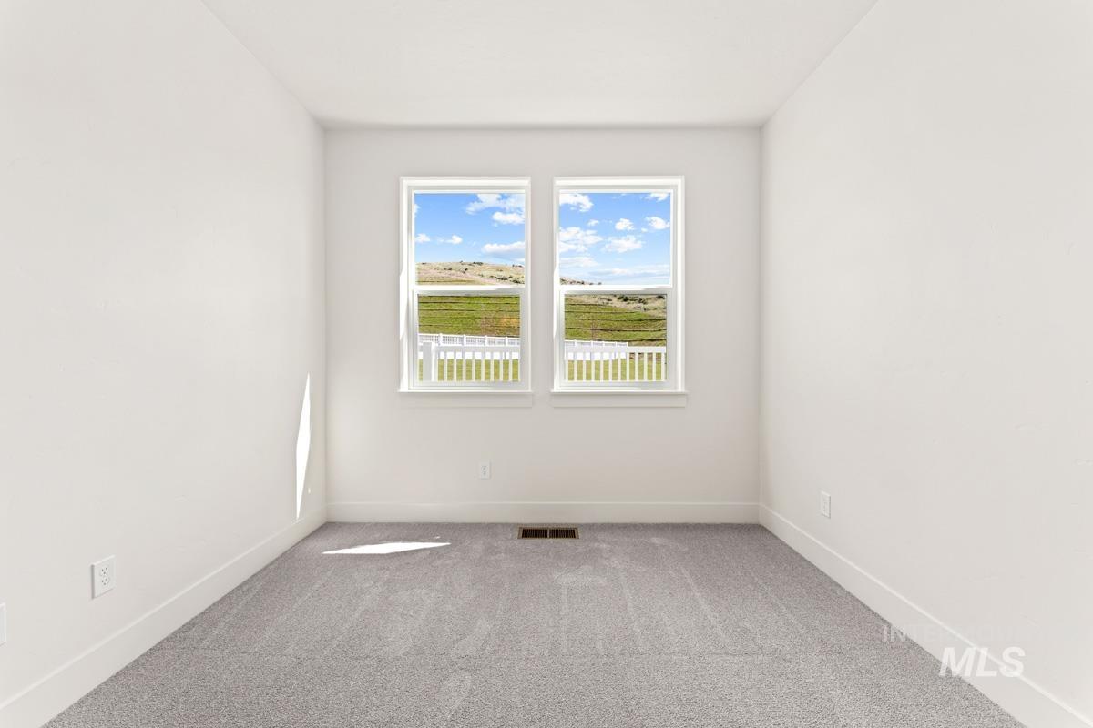 13374 North Spring Creek Way Boise, ID 83714 - Photo 30 of 49 Empty room featuring light colored carpet and baseboards