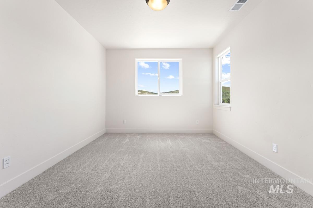 13374 North Spring Creek Way Boise, ID 83714 - Photo 32 of 49 Unfurnished room with light colored carpet and baseboards