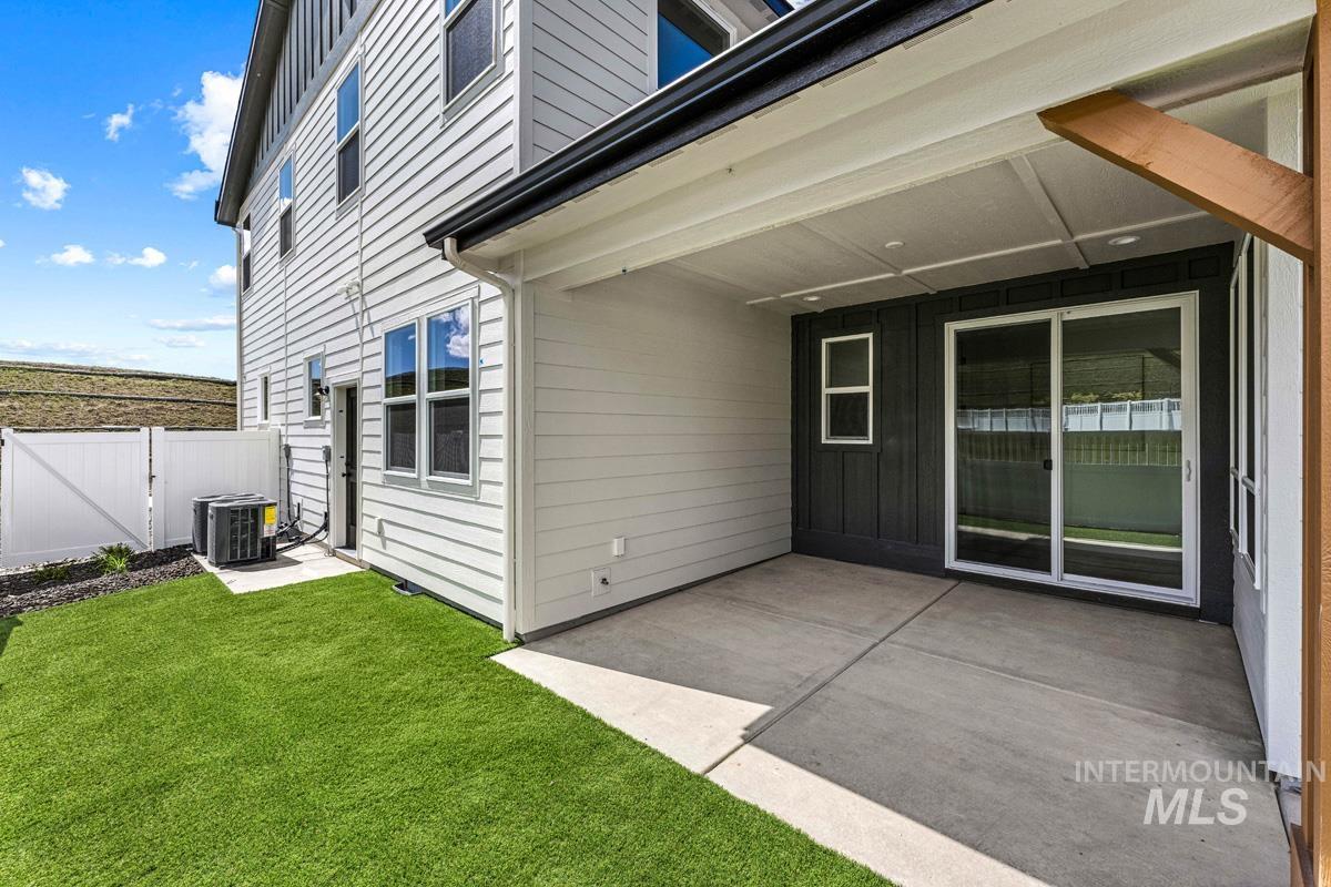 13374 North Spring Creek Way Boise, ID 83714 - Photo 35 of 49 View of exterior entry featuring a gate, a patio area, and board and batten siding