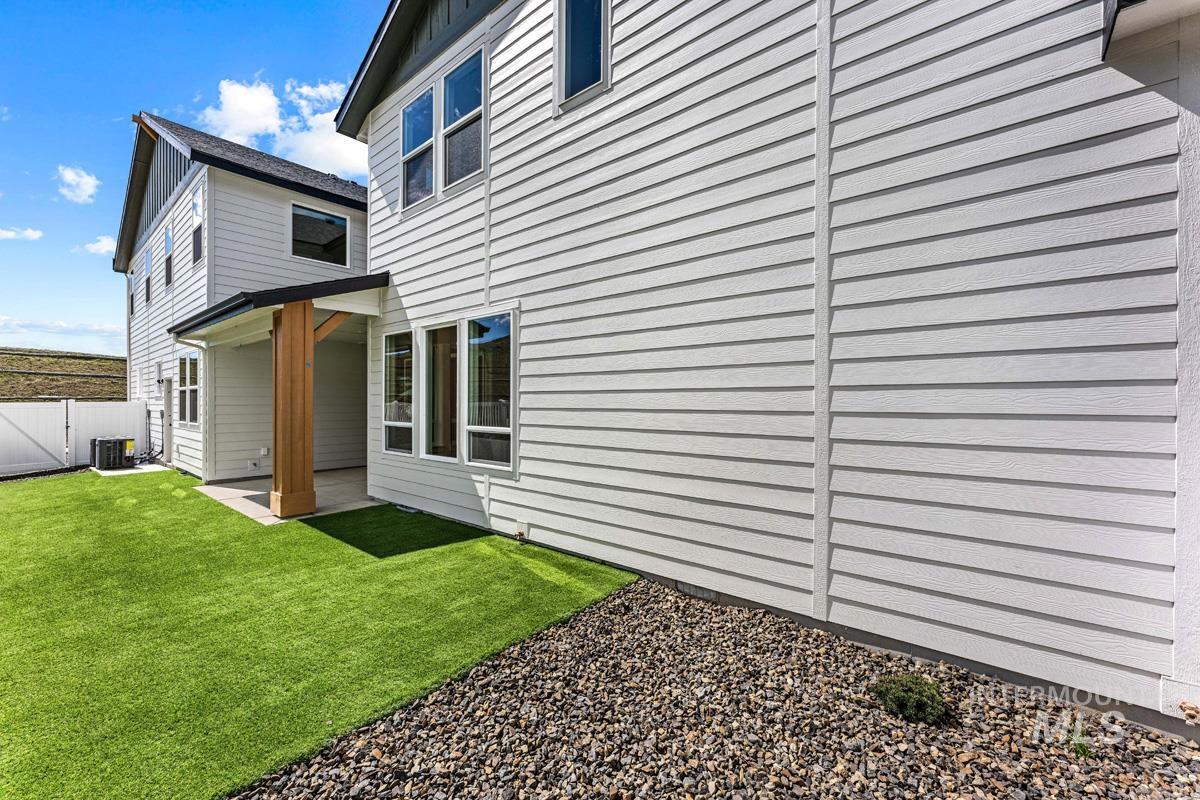 13374 North Spring Creek Way Boise, ID 83714 - Photo 36 of 49 View of side of home featuring a gate and a patio area