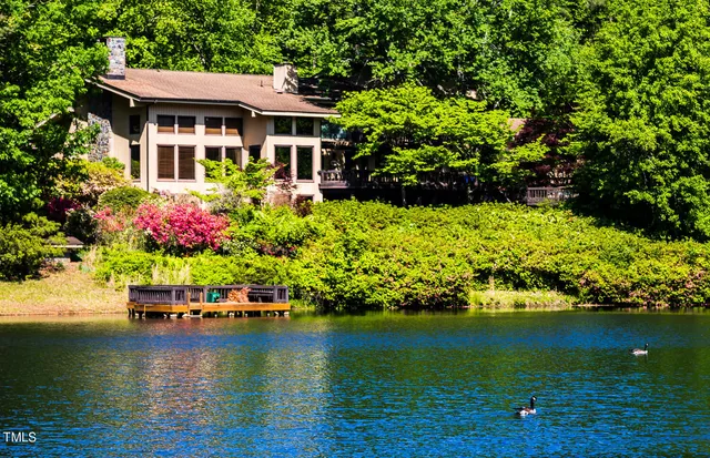 an aerial view of a house with a yard swimming pool and outdoor seating