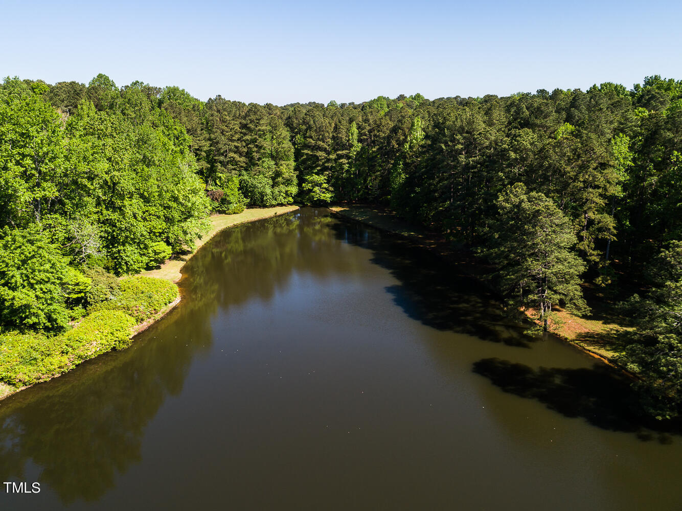 10305 Old Creedmoor Road Raleigh, NC 27613 - Photo 20 of 63 a view of a lake with a mountain in the background