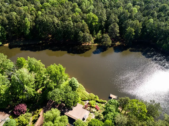 a living room with furniture a lamp and a large window