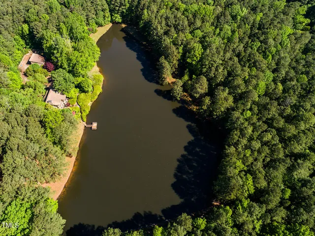 a dining room with furniture a floor to ceiling window and wooden floor