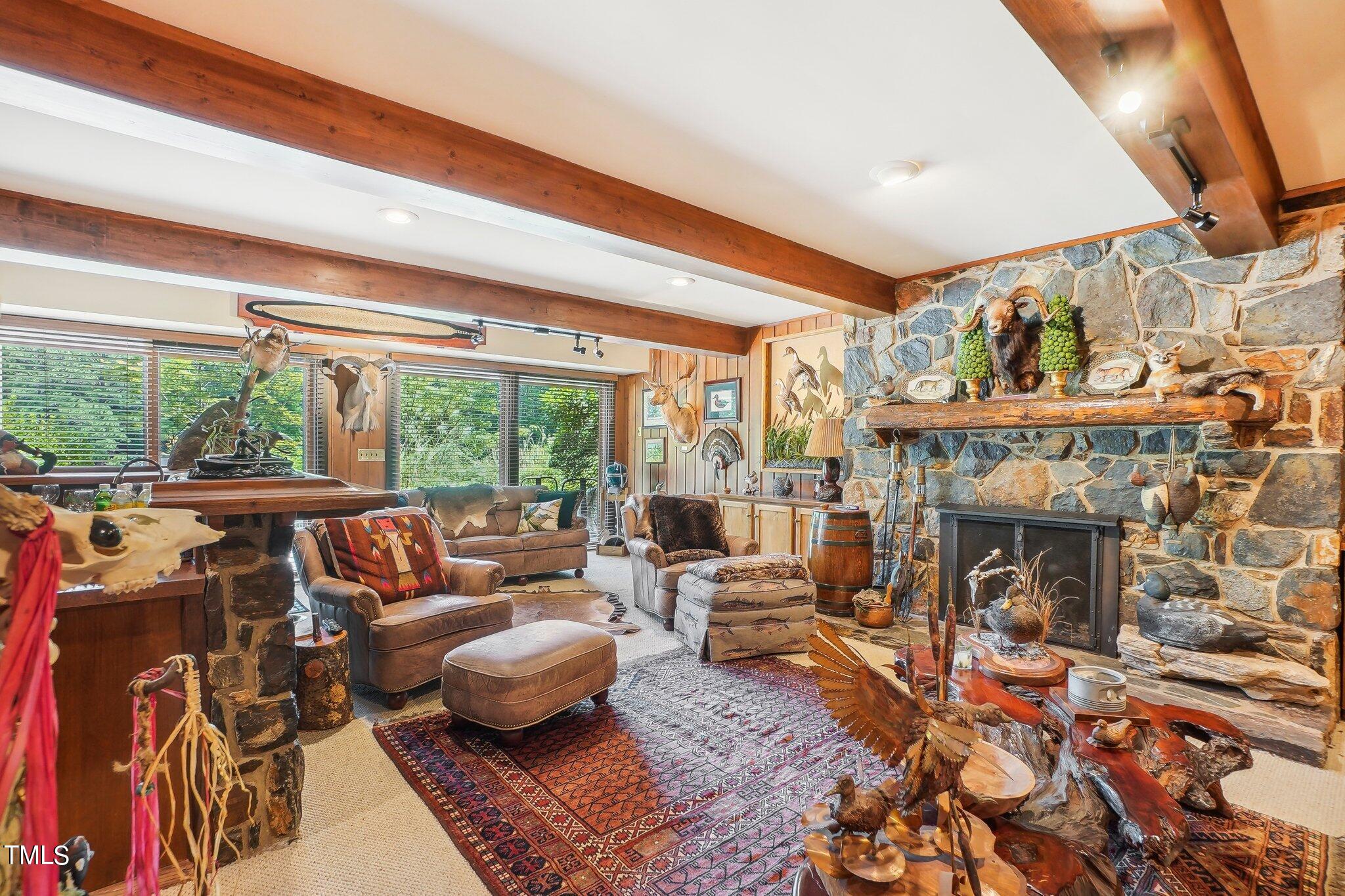 10305 Old Creedmoor Road Raleigh, NC 27613 - Photo 52 of 63 a living room with furniture and a fireplace