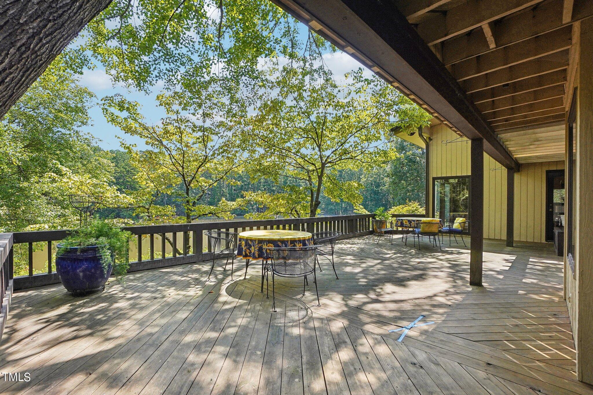 10305 Old Creedmoor Road Raleigh, NC 27613 - Photo 56 of 63 a view of a patio with a table chairs and a patio