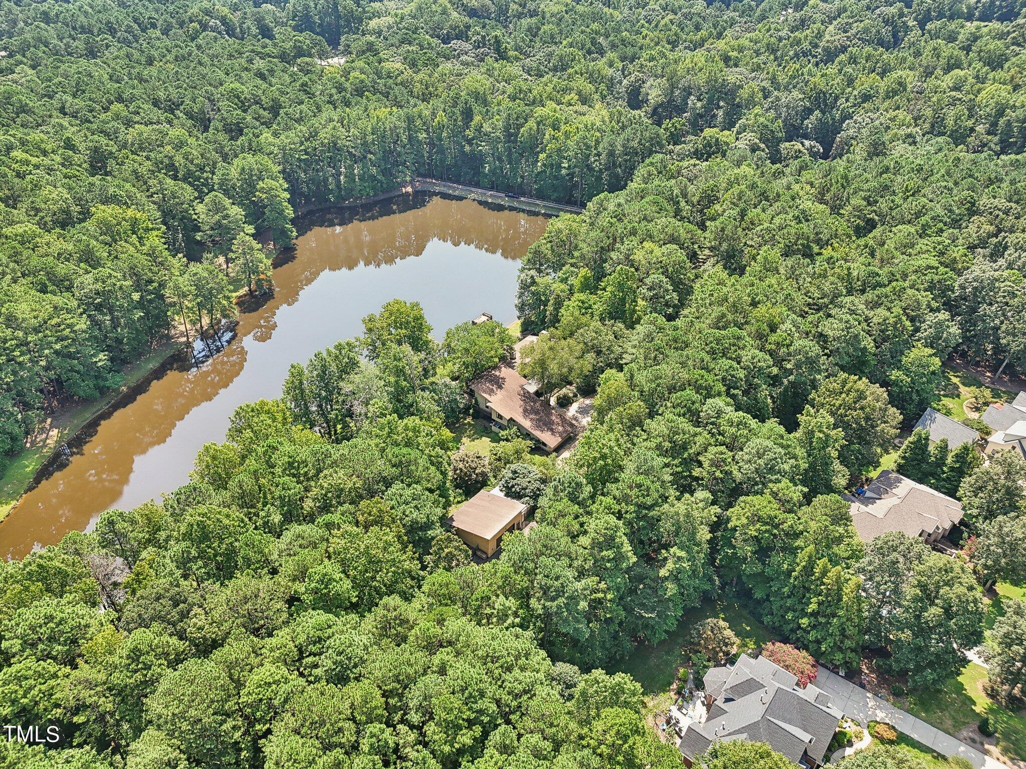 10305 Old Creedmoor Road Raleigh, NC 27613 - Photo 61 of 63 a view of a lake with a house