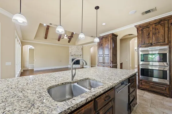 a kitchen with kitchen island a sink and a wooden floor