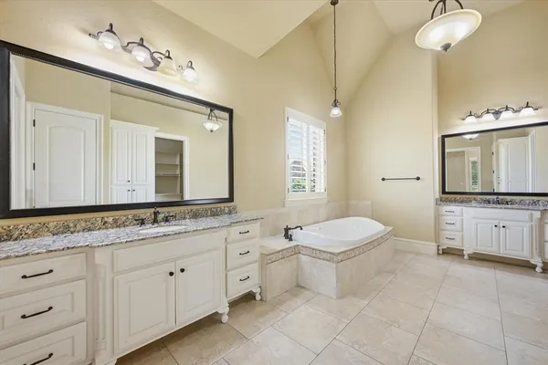 a spacious bathroom with a granite countertop sink mirror and a