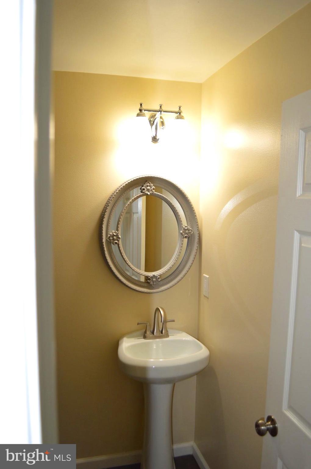 1339 West Lafayette Avenue, Unit 1 Baltimore, MD 21217 - Photo 11 of 24 a bathroom with a sink and mirror