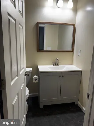 a bathroom with a toilet and a mirror