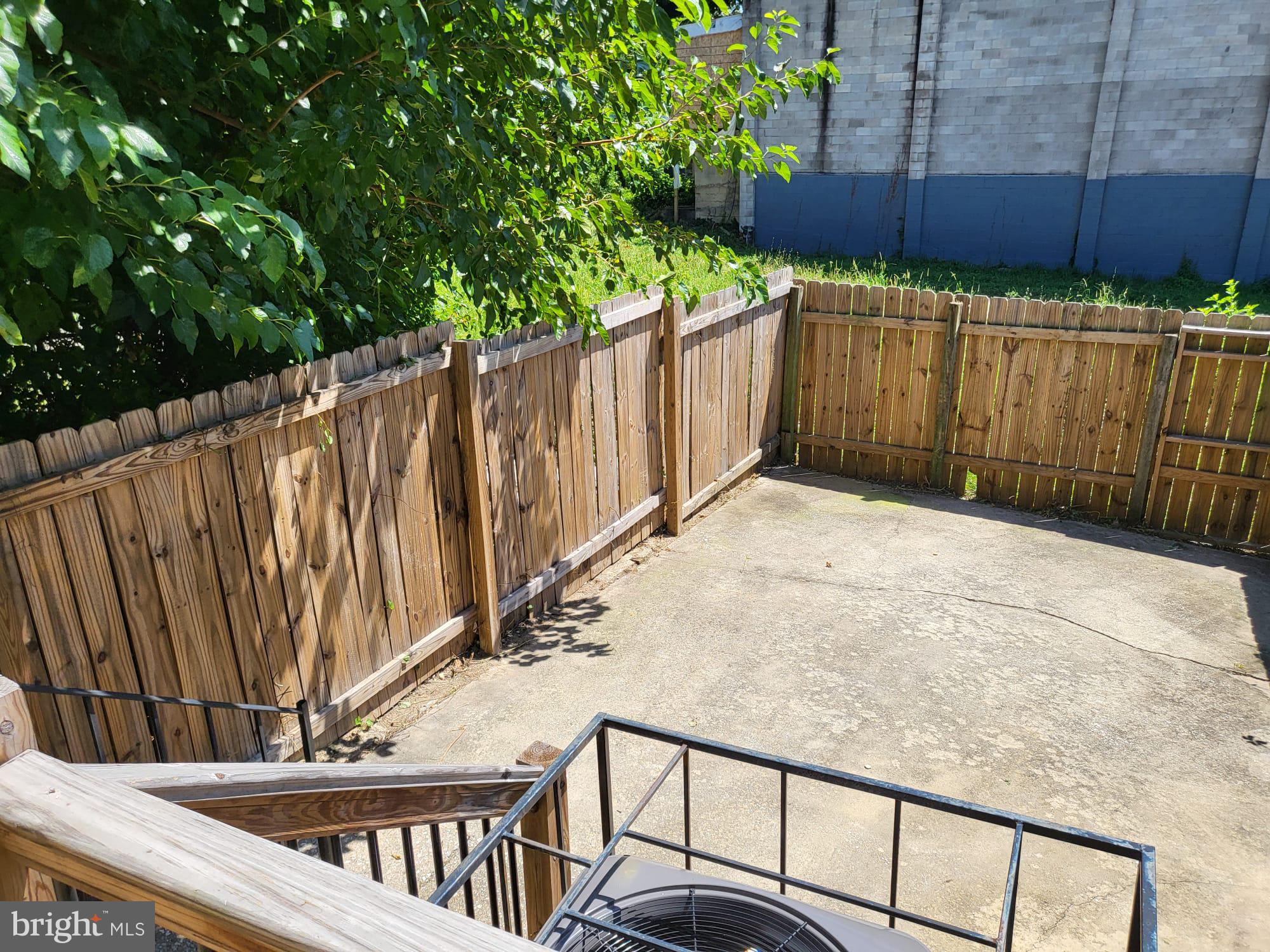 1339 West Lafayette Avenue, Unit 1 Baltimore, MD 21217 - Photo 21 of 24 a view of a backyard with wooden fence