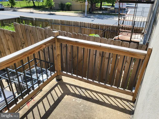 a view of a house with wooden fence