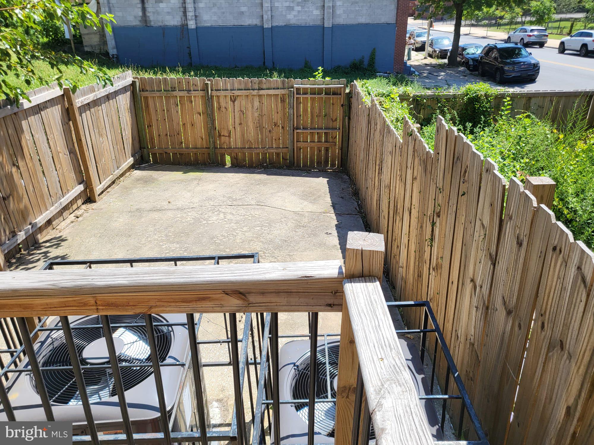1339 West Lafayette Avenue, Unit 1 Baltimore, MD 21217 - Photo 23 of 24 a view of a backyard with wooden fence