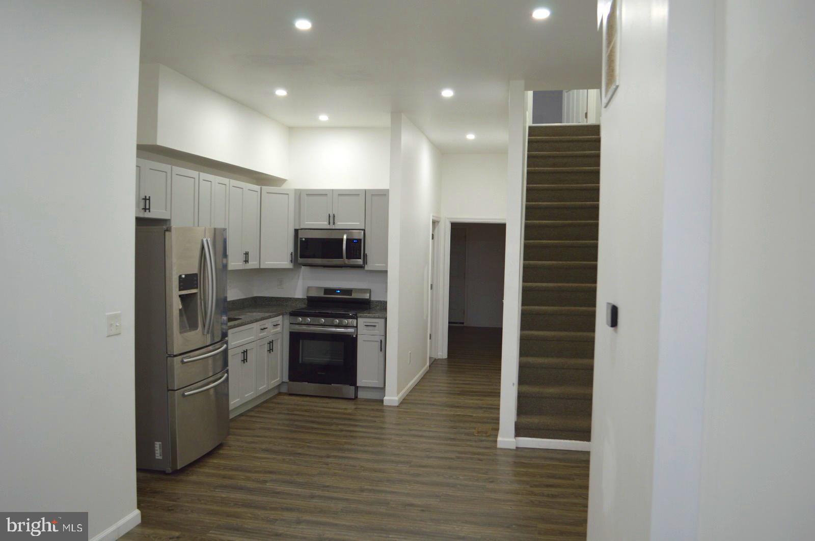 1339 West Lafayette Avenue, Unit 1 Baltimore, MD 21217 - Photo 7 of 24 a kitchen with stainless steel appliances a refrigerator and a stove top oven