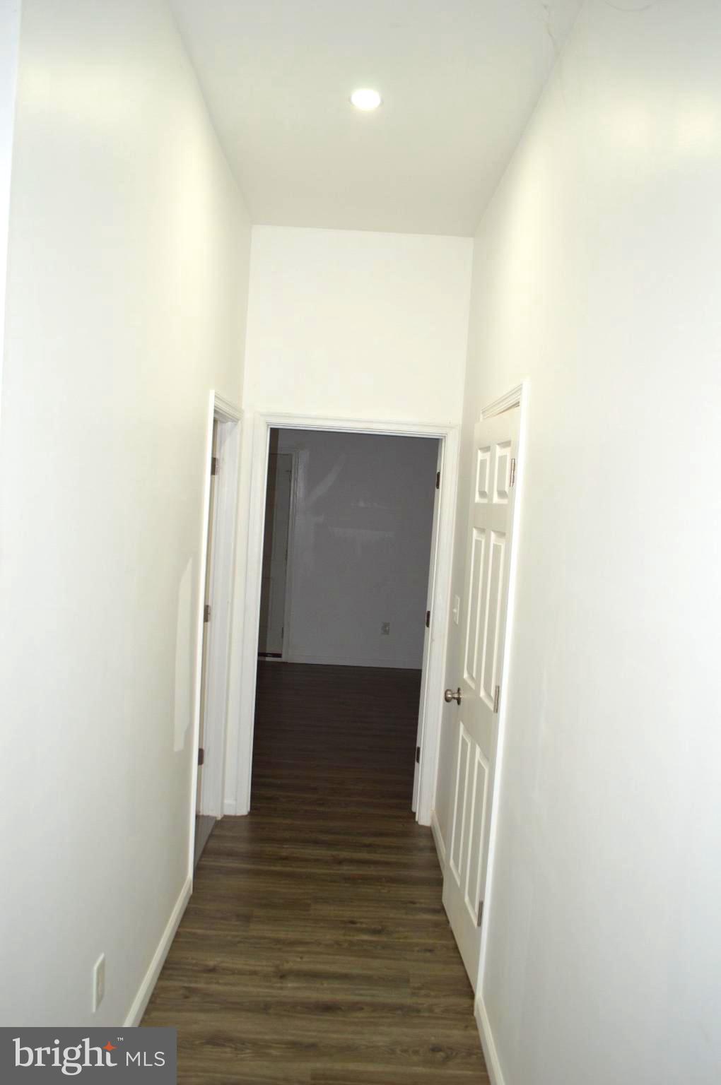 1339 West Lafayette Avenue, Unit 1 Baltimore, MD 21217 - Photo 10 of 24 a view of a hallway with wooden floor