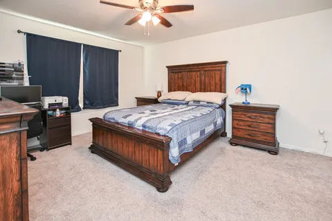 a bedroom with a bed and a chandelier