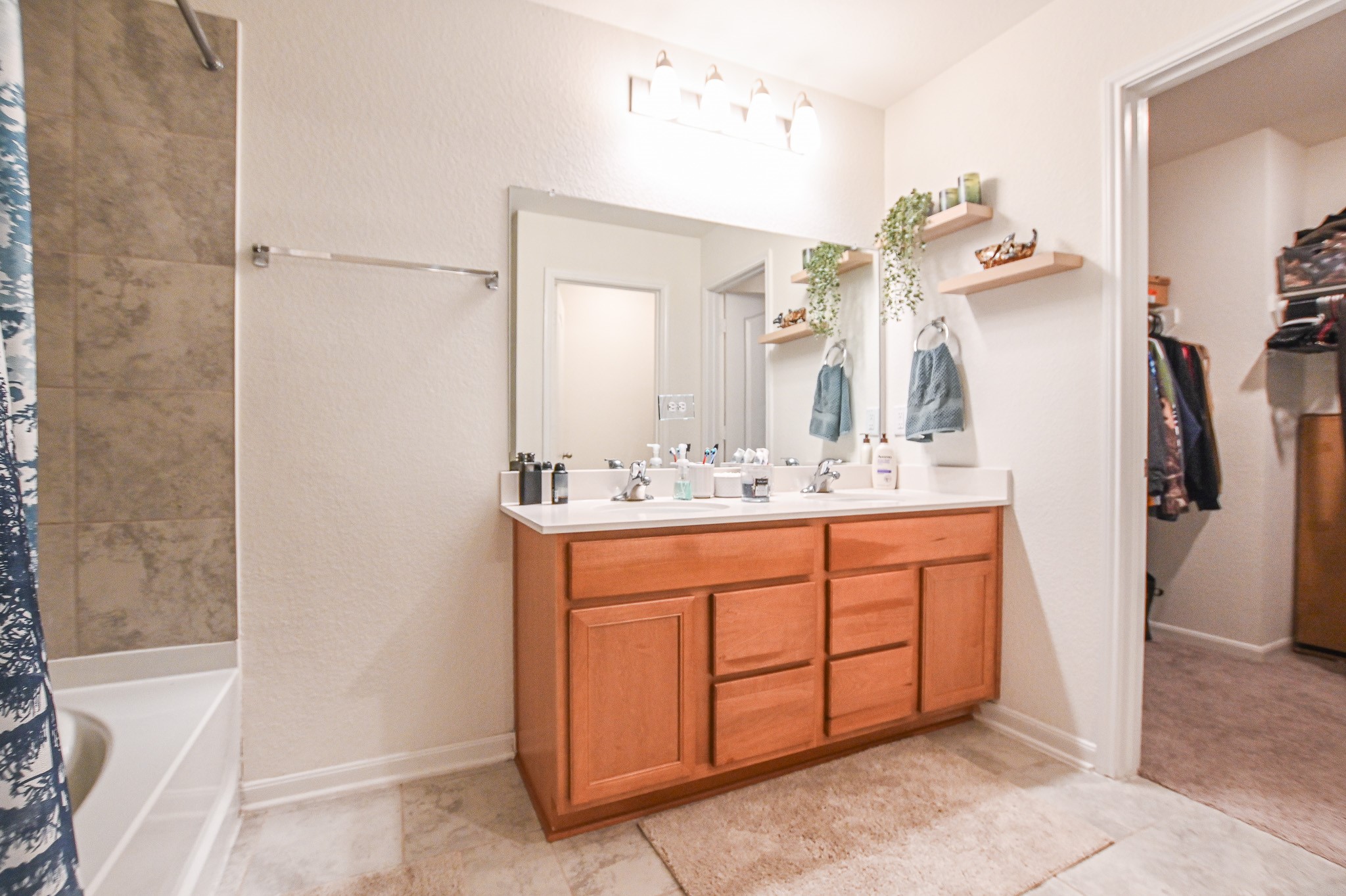 5920 Bluebonnet Lane Rosenberg, TX 77469 - Photo 19 of 24 Primary Bath has generous space, with dual sink vanity and tiled tub shower combo.