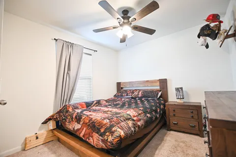 a bed sitting in a bedroom next to a window