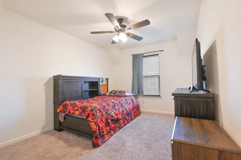 a bedroom with a bed and window