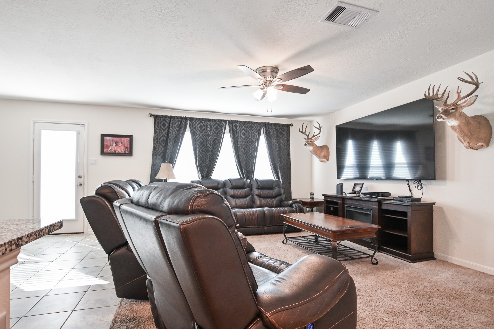 5920 Bluebonnet Lane Rosenberg, TX 77469 - Photo 10 of 24 Open and inviting living room filled with natural light filtering through the windows curtains.