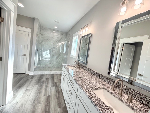 6421 Lynchburg Road Winchester, TN 37398 - Photo 12 of 25 a bathroom with a granite countertop sink a mirror and shower
