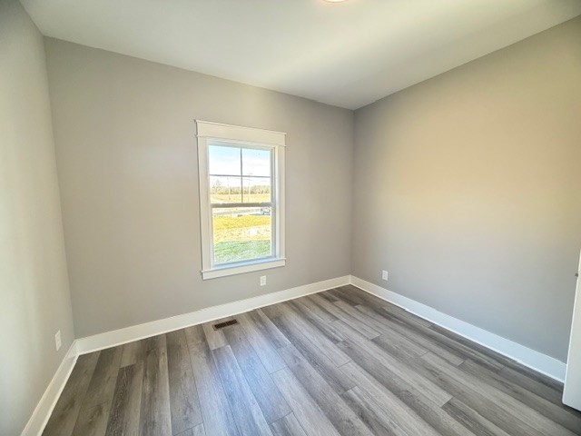 6421 Lynchburg Road Winchester, TN 37398 - Photo 19 of 25 an empty room with wooden floor and windows