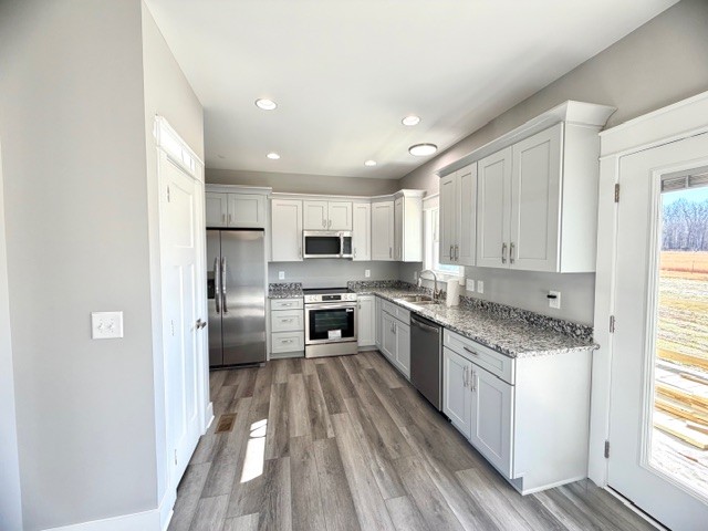 6421 Lynchburg Road Winchester, TN 37398 - Photo 8 of 25 a large kitchen with a white stove top oven and refrigerator