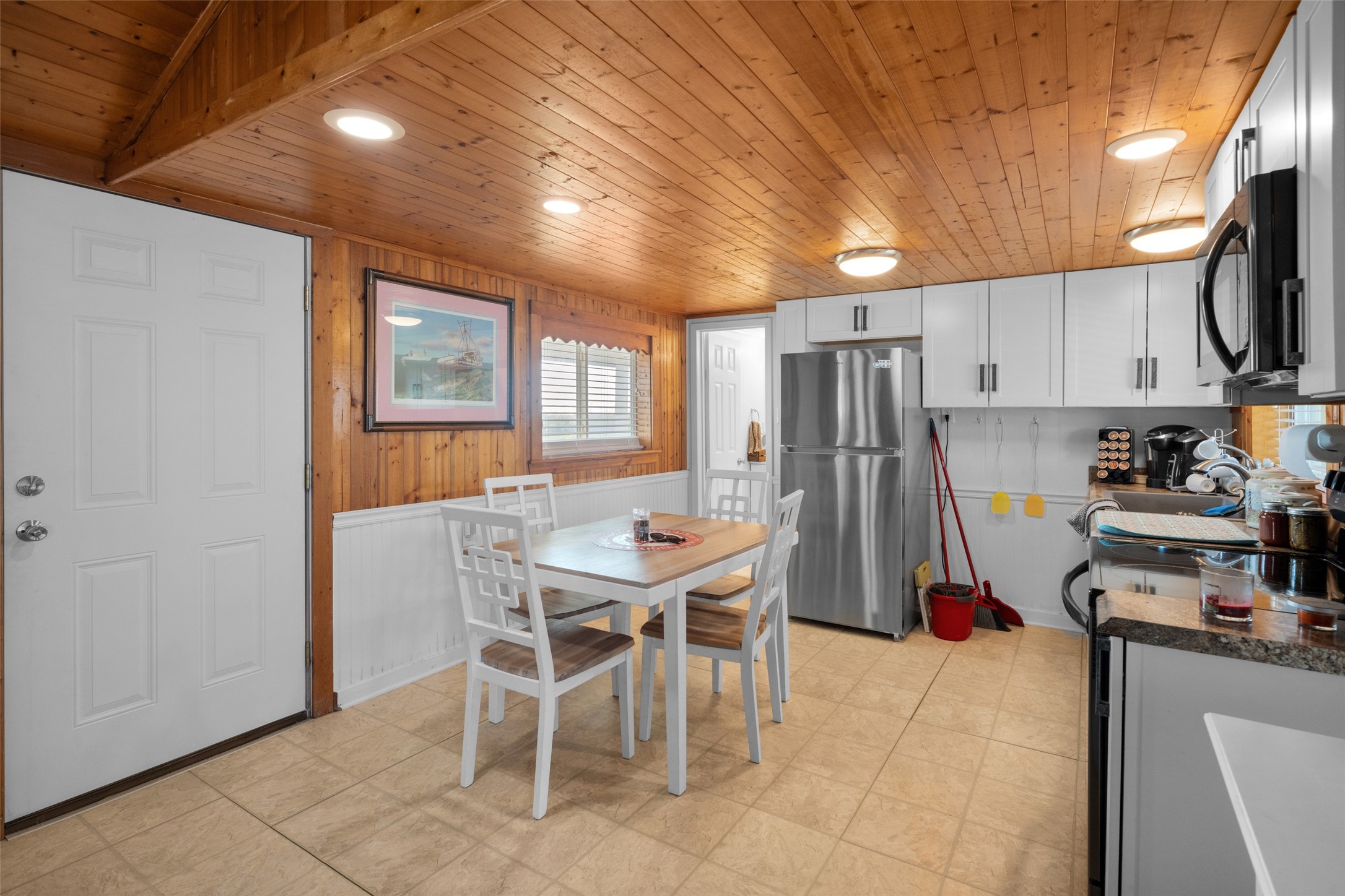3130 Fm-2031 Matagorda, TX 77457 - Photo 15 of 25 a kitchen with stainless steel appliances granite countertop a refrigerator a stove a sink a dining table and chairs with wooden floor
