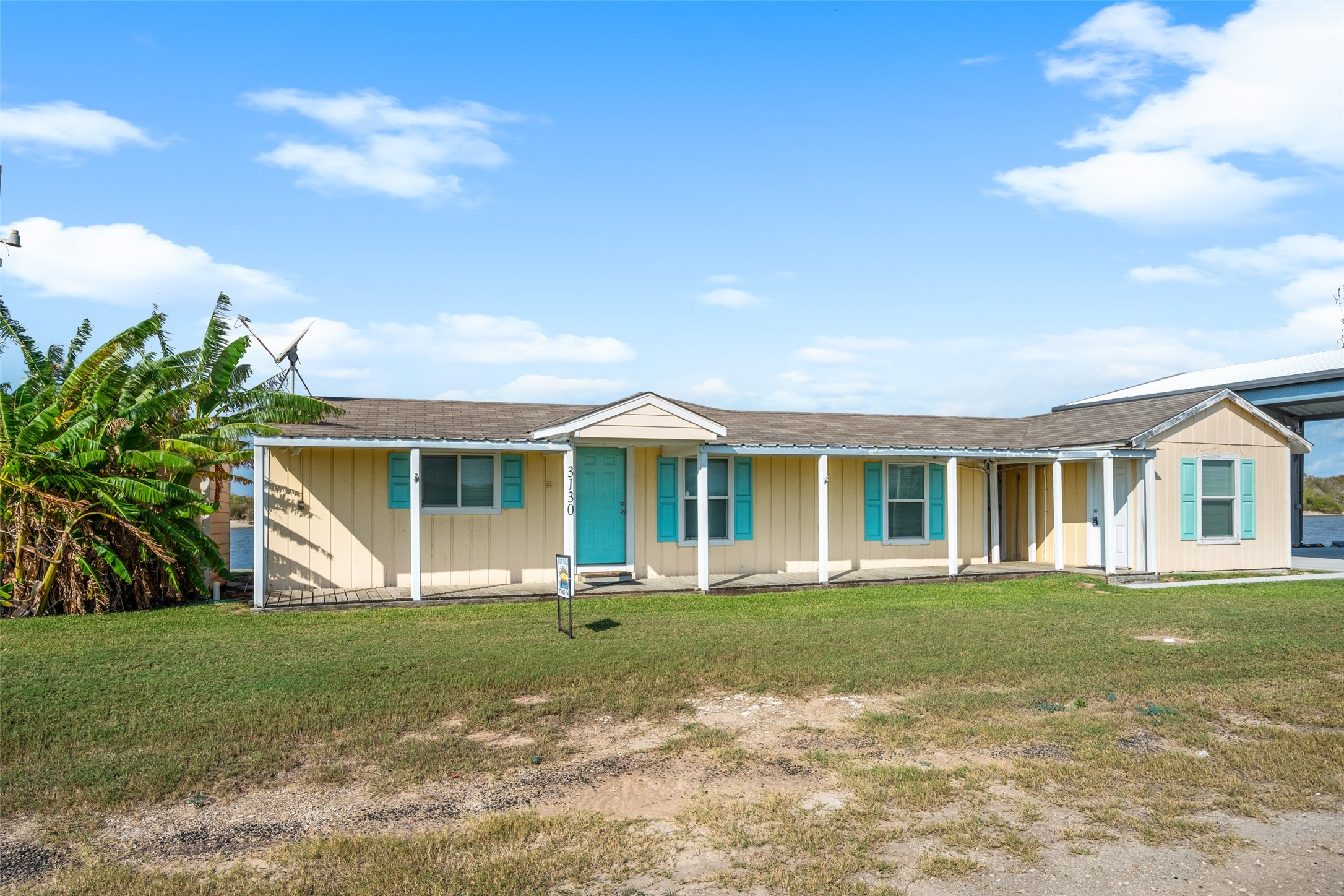 3130 Fm-2031 Matagorda, TX 77457 - Photo 2 of 25 a front view of a house with a yard and trees