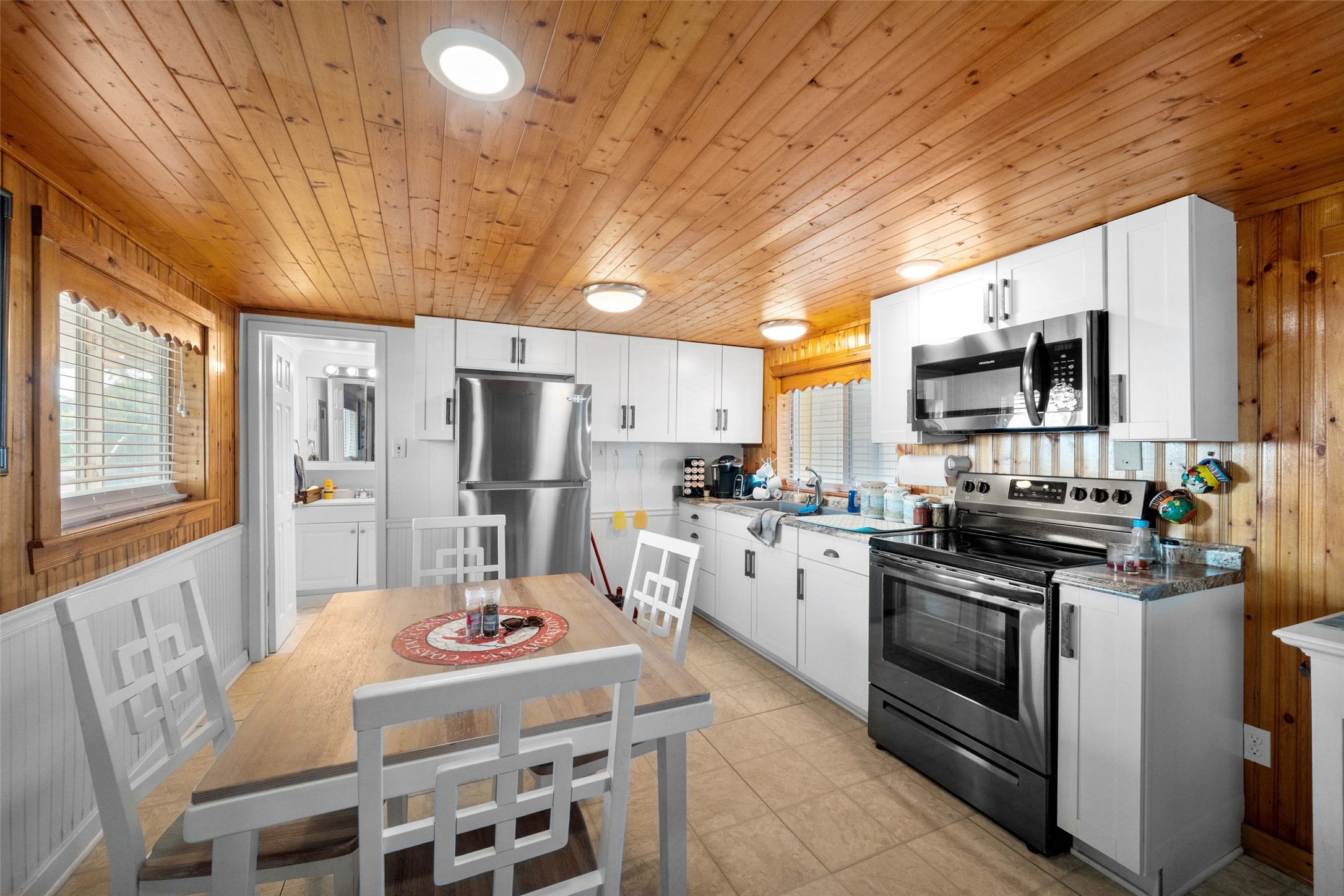 3130 Fm-2031 Matagorda, TX 77457 - Photo 10 of 25 a kitchen with stainless steel appliances a stove a refrigerator island a stove a sink dishwasher a dining table and chairs with wooden floor