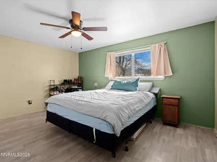 a bedroom with a bed and window